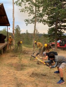 People preparing a home for wildfire mitigation