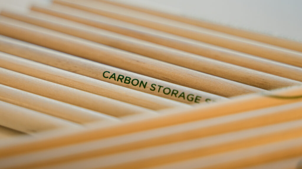 Closeup of wooden pencils with the words 'Carbon Storage' written on them.