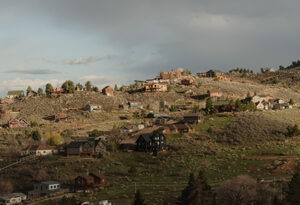 A community intersects with trees, grasses and hills along the wildland-urban interface.