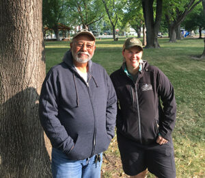 two urban and community foresters from the Colorado State Forest Service smile at the camera.