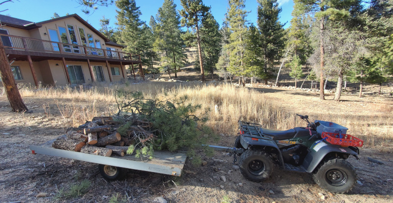 Removing brush around a home as a wildfire mitigation activity.